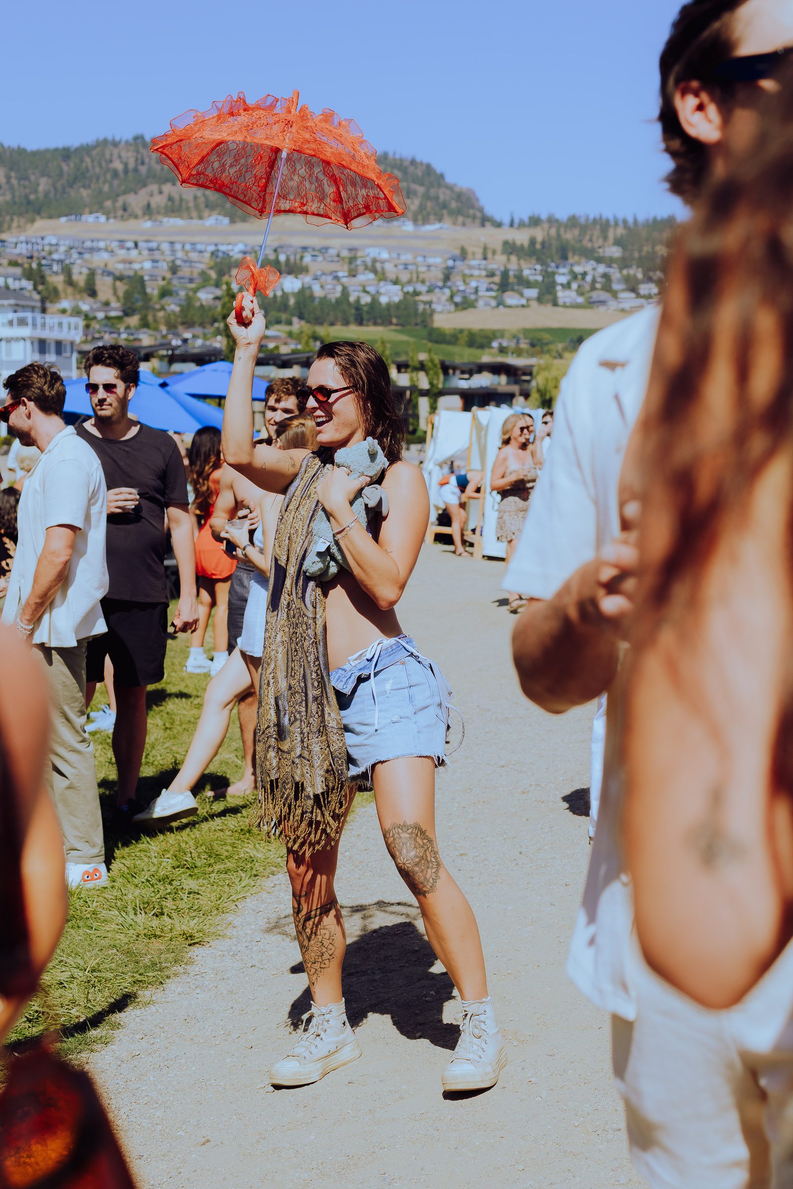 Woman dancing with a red parasol raised