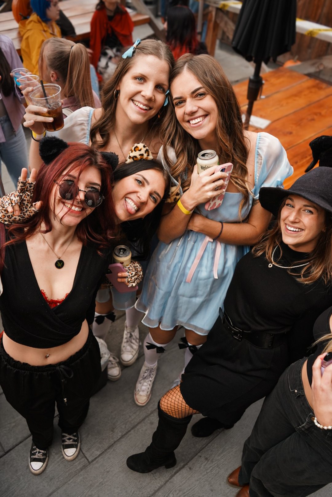 Friends laughing together with drinks in hand