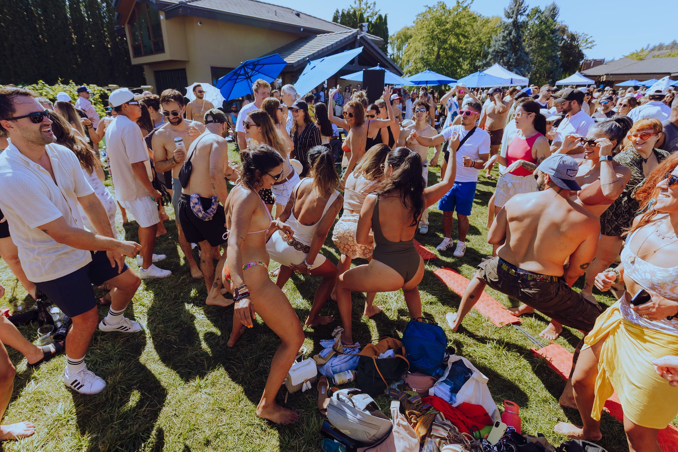 A packed grass dancefloor in full sun