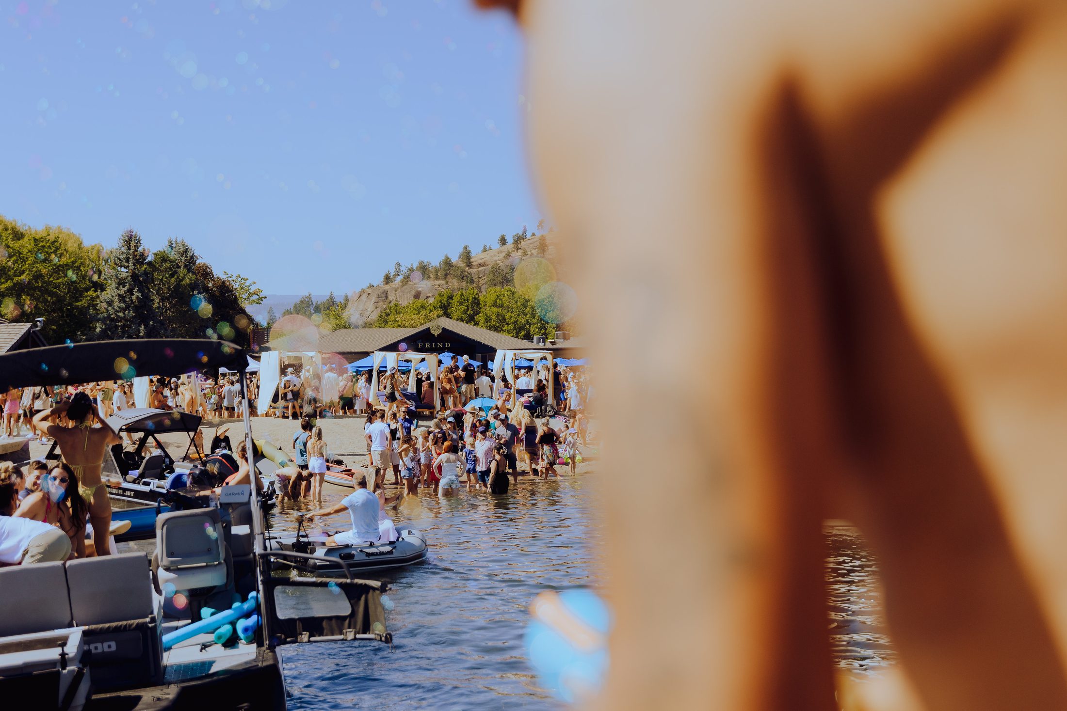 Boats and crowd along the Okanagan lakeshore