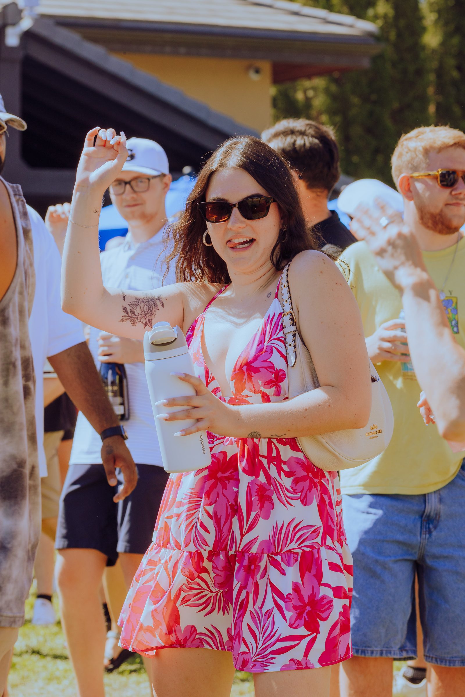 Woman in a red floral dress dancing in the crowd
